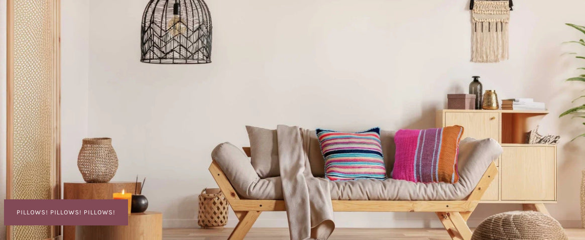 Colorful VinLoom handwoven Peruvian pillows on a natural wood sofa in a warm living room