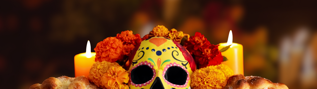 Day of the Dead altar with painted sugar skull, marigold flowers, candles, and pan de muerto, honoring tradition, remembrance, and cultural heritage.