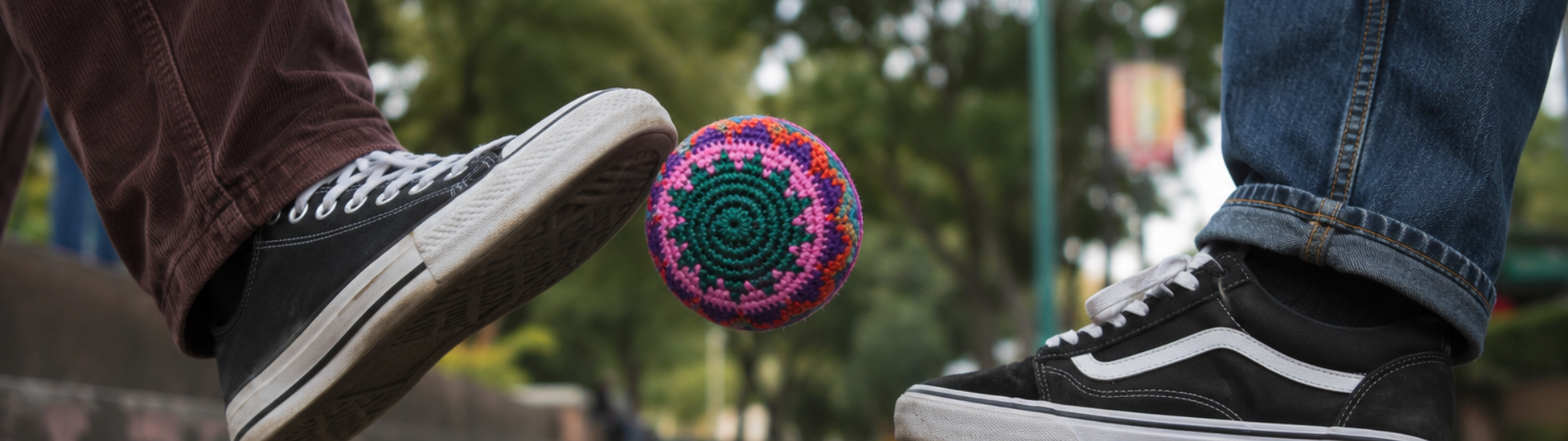 Person playing with a colorful Lumily handmade Guatemalan hacky sack outdoors