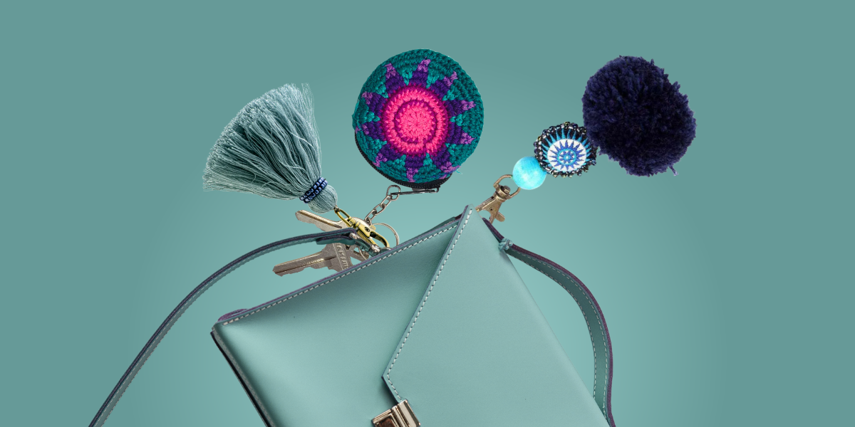 bag charms of different colors on a blue bag